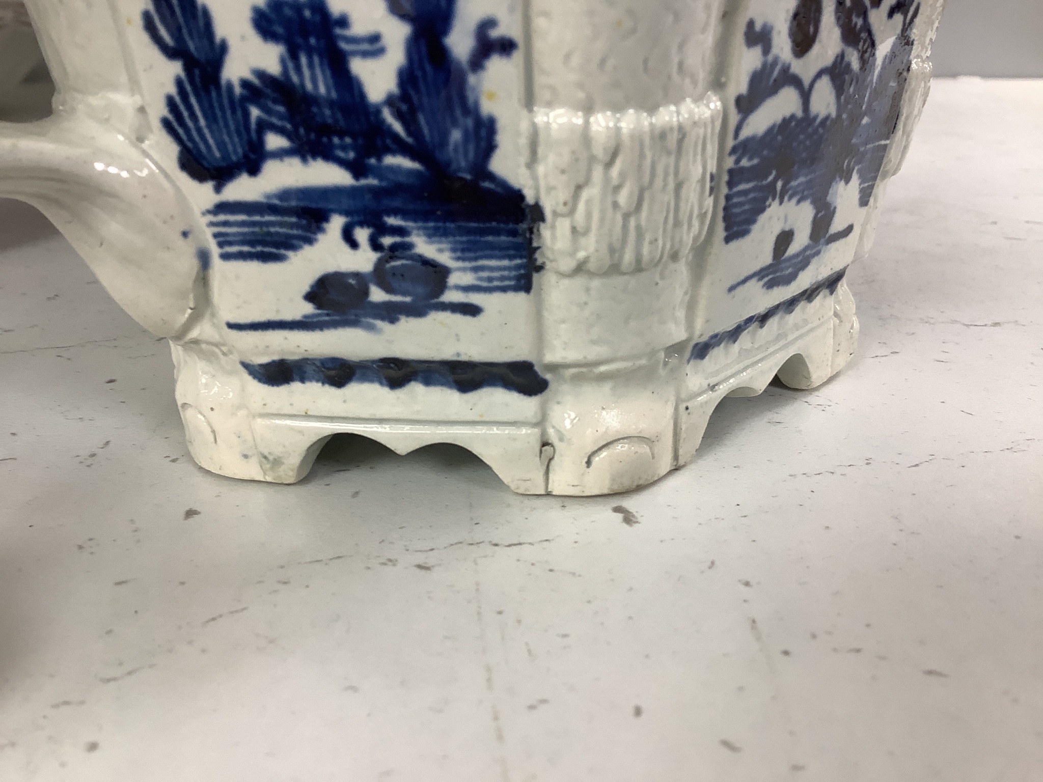 A collection of English blue and white pottery, various dates, comprising a moulded hexagonal teapot and cover, with widow finial, ovoid teapot and cover, lozenge section sugar bowl and cover, with swan finial, circular